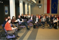 Zdjęcie sali i uczestników sesji warsztatowej. Wszyscy siedzą słuchając uważnie. 